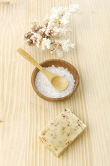 Salt on spoon ,soap , massage oil on a wooden board