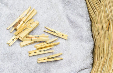 A bunch of clothes peg and laundry in a wicker basket