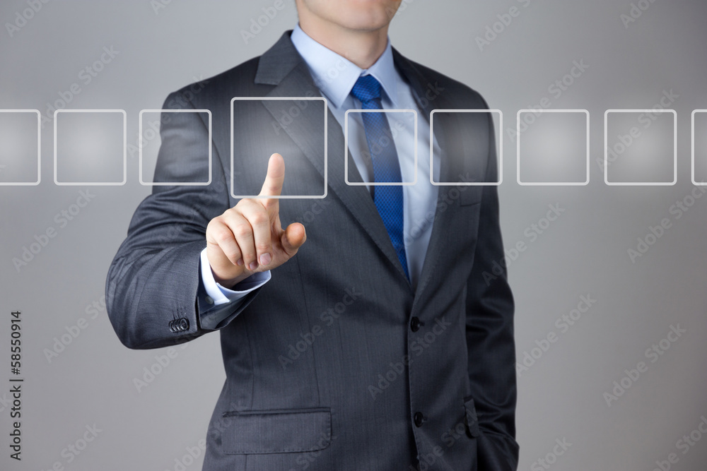 Wall mural business man pushing on a touch screen interface