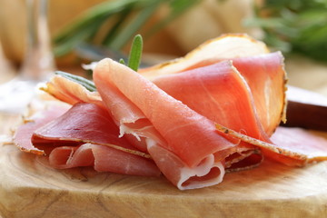 parma ham (jamon) sliced ​​on a wooden board