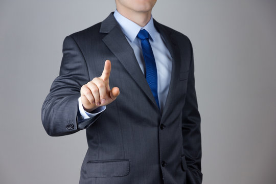 Business man touching an imaginary screen