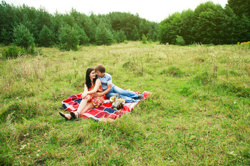Happy young couple spending time together in park