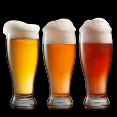 Different beer in glasses isolated on white background