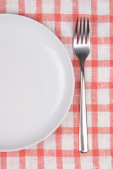 plate and fork over checkered background