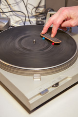Two fingers and a skateboard on a turntable