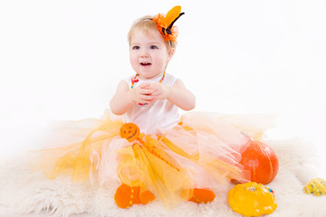 Baby girl with pumpkin