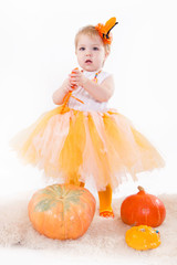 Baby girl with pumpkin