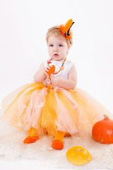 Baby girl with pumpkin