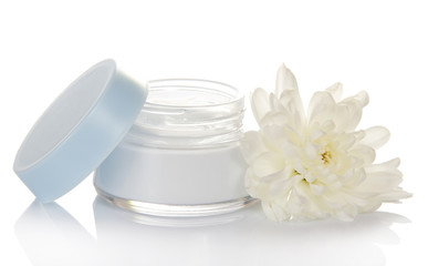 Glass container of cream and fresh flower