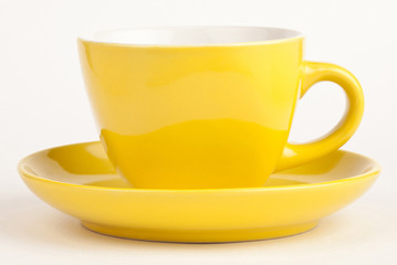 Empty yellow cup isolated on white