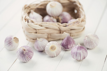 Chinese solo garlic in traditional wicker basket, studio shot