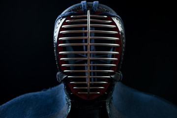Front view of kendo helmet over black background, studio shot