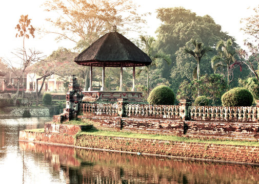 Bali.Traditional pavilion in park over the lake