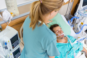 Nurse Adjusting Patient's Pillow