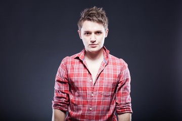 Portrait of casual young man in red checkered shirt