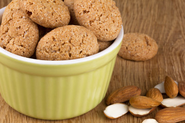almond cookies in a ceramic dish with almonds