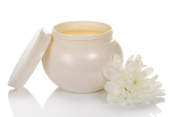 Fototapeta na wymiar Open jar with a face cream and flower