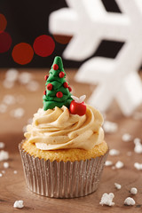 Xmas tree cupcake on Christmas background