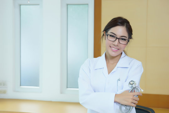 Portrait of happy successful young female doctor holding a steth