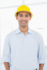 Portrait of a smiling handyman wearing a yellow hard hat
