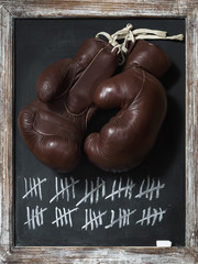 old Boxing Gloves on Chalkboard with Tally Sheet