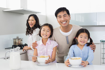 Family of four having breakfast in the kitchen
