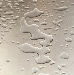Fototapeta na wymiar water on silver metal table in harmonic form