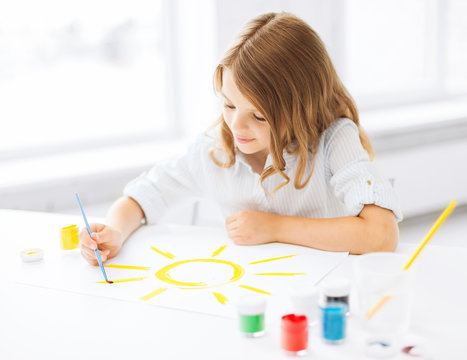 little girl painting picture