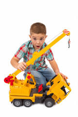 Obraz na płótnie Canvas little boy plays with toy truck