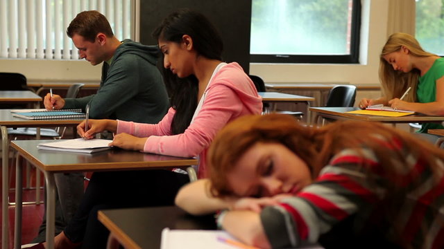 Student asleep at her desk in class