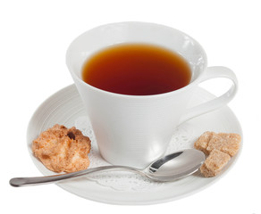 A cup of tea and a traditional French pastry isolated on white b