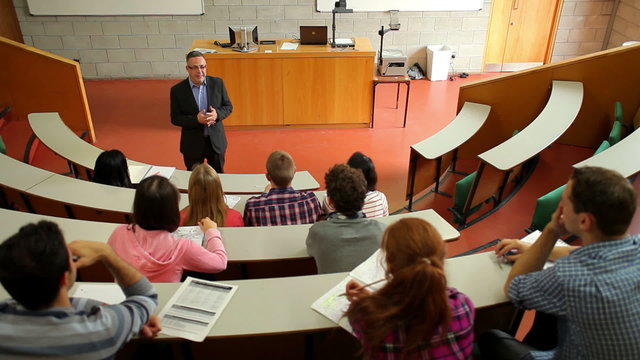 Lecturer speaking to his class in the lecture hall