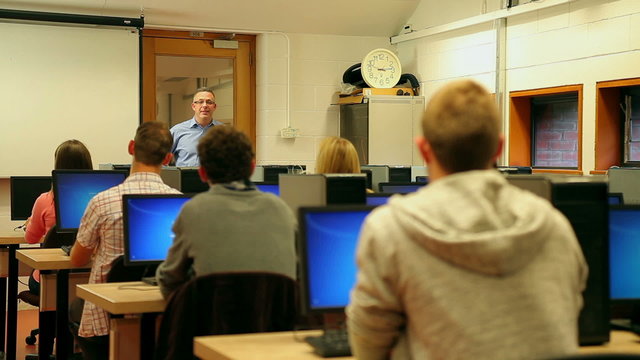 Students listening to lecturer in computer room