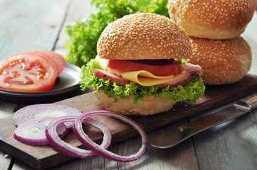 Sandwich with ham, cheese,  tomato and lettuce