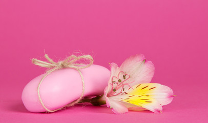 Pink toilet soap connected by a twine and the flower