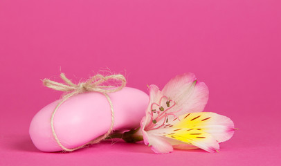 Pink toilet soap connected by a twine and the flower