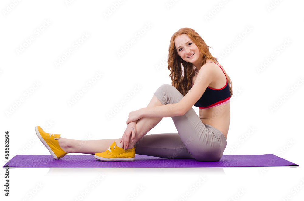 Wall mural young sporty woman doing exercises on white