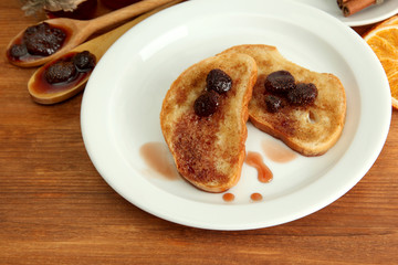 White bread toast with jam on wooden table