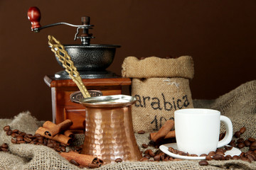 Metal turk and coffee cup on dark background