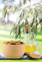 Olive oil and olives in bowl