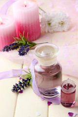 Glass bottle with color essence, on wooden background