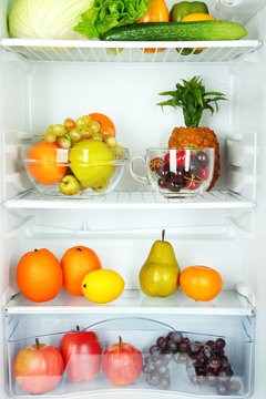 Vegetables and fruits in open refrigerator. Weight loss diet