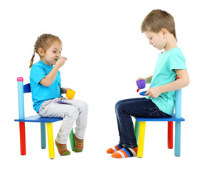 Little children playing with colorful tableware isolated