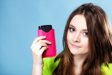 Happy girl with mobile phone in pink cover