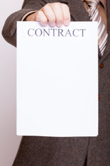 Businessman holding blank paper with sign contract