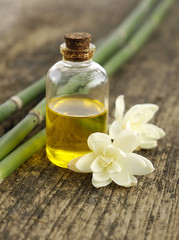 White Gardenia with spa oil in glass and grove on driftwood