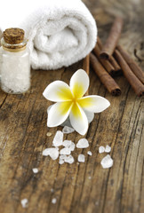 frangipani flower with cinnamon,salt with towel on old wood