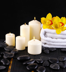 Obraz na płótnie Canvas Spa feeling with branch yellow orchid ,towel ,candle pebbles