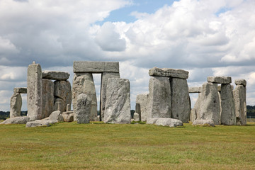 Stonehenge historic site on green grass under blue sky. Stonehen