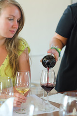 Red wine is pouring into wine glass